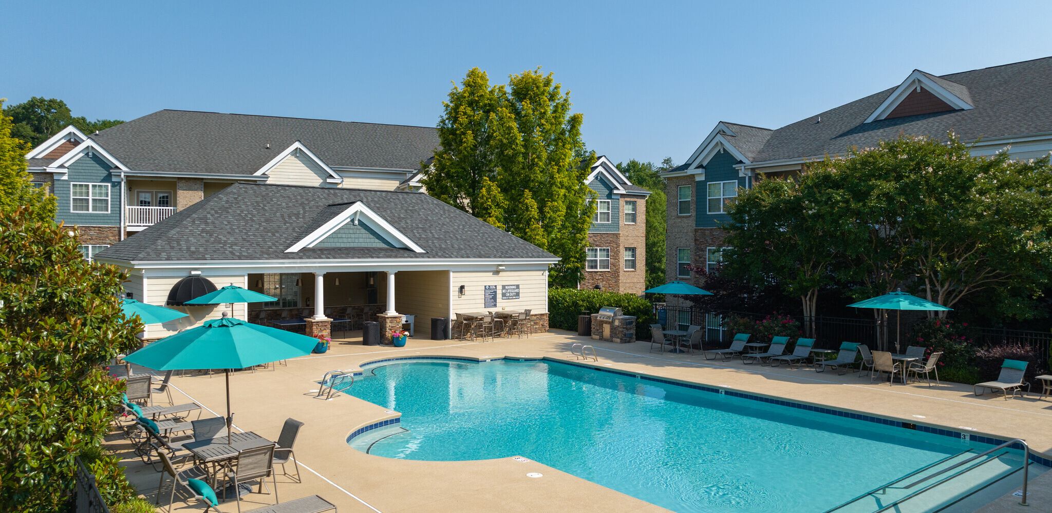 Hawthorne at Horse Pen Creek luxury outdoor pool with lounge chairs and surrounding seating